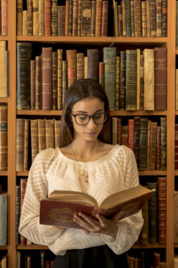 smart-woman-reading-book-library